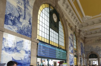 Azulejos tiles and clock interior Sao Bento railway station building, city of Porto, Portugal,