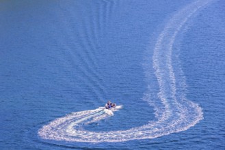 Motorboat that has made a turn on the sea with white wake pattern, Crozon peninsula, Bretagne,