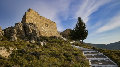 Rock ruins with path and tree, under a wide blue sky with clouds, Archangelos, castle, place,