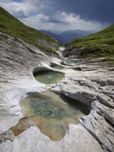 Glacier mill with glacier pots on the Trinser Alp Mora, Trin, Canton Graubünden, Switzerland,