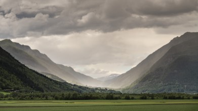 Impressive mountain landscape with dramatic sky, low-hanging rain clouds and play of light in the
