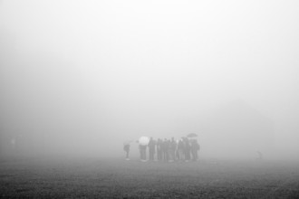 Group of visitors in the fog at beech forest concentration camp, today a concentration camp