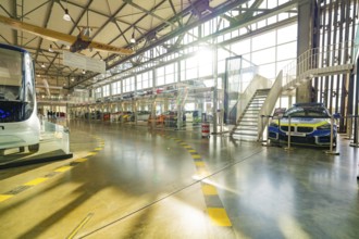 Hall with glass garage full of cars, direct sunlight and modern architecture, Motorworld Böblingen,