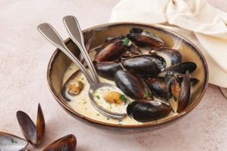 Mussels in creamy garlic sauce, served with fresh herbs and spices, homemade, no people
