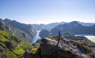 Mountaineer, young man hiking in front of mountain landscape, fjord Trollfjord and mountains, hike