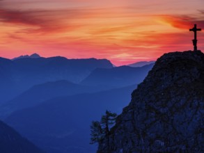 Cross on the summit of the Kleiner Jenner at dusk, Reiteralpe in the background, Berchtesgaden