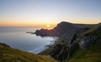 View of coastal landscape at sunset, cliffs and summit of Måtind or Måtinden, Høyvika beach and