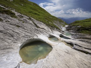 Glacier mill with glacier pots on the Trinser Alp Mora, Trin, Canton Graubünden, Switzerland,