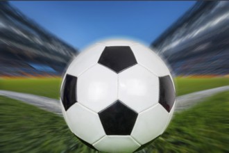 Symbolic image of football: Close-up of a black and white football in a football stadium