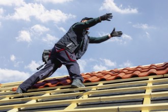 Roofer covering a tiled roof