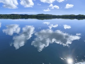 Reflection of white clouds cumulus in lagoon of Yap Island in Pacific Ocean, Caroline Islands, Yap