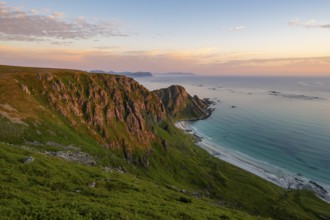 View of coastal landscape at sunset, cliffs, Høyvika beach and sea, hike to the summit of Måtind or