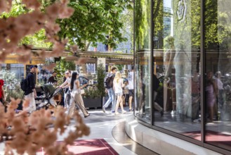 Königsallee Düsseldorf with passers-by. The Kö is one of the most luxurious shopping streets in