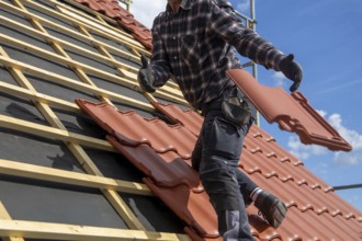Roofer covering a tiled roof