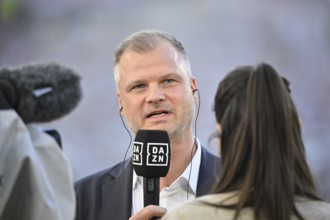 Chief Sports Officer Fabian Wohlgemuth VfB Stuttgart in front of TV camera in interview Microphone