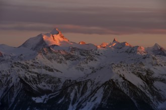 Sunset with Alpine glow over snow coverd mountains, Valais Alps, Switzerland, Europe
