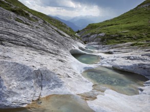 Glacier mill with glacier pots on the Trinser Alp Mora, Trin, Canton Graubünden, Switzerland,