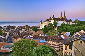 Neuchâtel Castle with view over the town of Neuchâtel at dawn, Lake Neuchâtel behind, Canton of