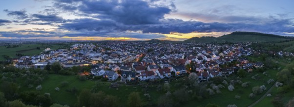 City lights at dusk with hills and dense clouds in the sky, Korb-Steinreinach, Rems Valley,