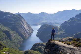 Mountaineer, young man in front of mountain landscape, fjord Trollfjord and mountains, hike to