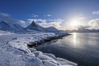 Snowy landscape with mountains and fjord, Volandstinden mountain, Fredvang, Flakstadøya, Lofoten,