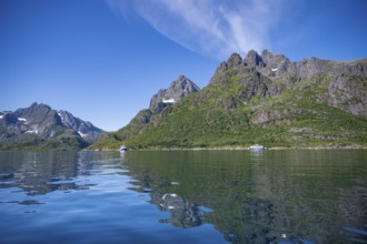 Mountain peaks at Raftsund reflected in the water, fjord landscape with mountains, Lofoten,