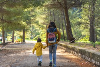 Mother and son enjoying a peaceful walk through the natural beauty of la fontcalda, a sanctuary