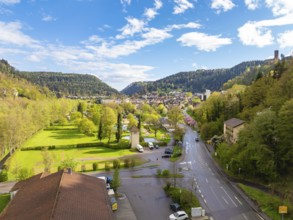 View of town with neighbouring forest and hills under blue sky, Bad Liebenzell, district Calw,