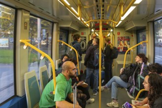 People on metro tram train public transport system, city of Porto, Portugal, Europe