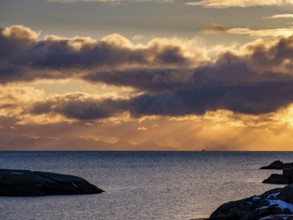 Morning atmosphere at the coast of Ballstad, behind the mountains of the mainland, Vestvagoy