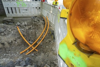 Laying of fibre optic cables, empty conduits are laid under a pavement, in which the actual fibre