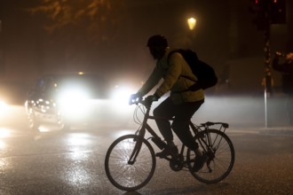 Cyclist, darkness, inner city traffic, fog, autumn, winter, evening traffic, North