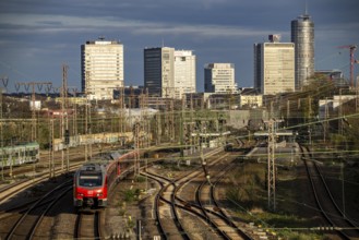 Train on the tracks west of Essen central station, city centre skyline, regional express train,