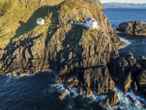 Aerial view of Krakenes Fyr lighthouse, lighthouse located on steep cliff, norwegian coast north of