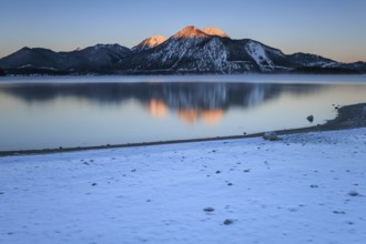 Sunrise over mountain lake, reflection, winter, Walchensee, view of Herzogstand and Heimgarten,