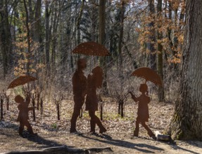 Rusty figures with umbrella, art installation on the grounds of the former tuberculosis sanatorium