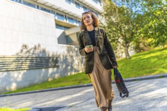 Full length photo of a beauty Arab businesswoman in casual modest clothes walking along the city