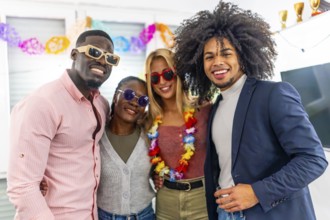 Portrait of four multi-ethnic people smiling at camera during a home party