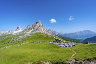 Panoramic view of the parking area at passo giau in the dolomites on a sunny summer day,