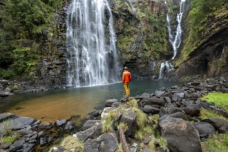 Young man standing in front of a waterfall, Lisbon Falls, long exposure, near Graskop, Mpumalanga,