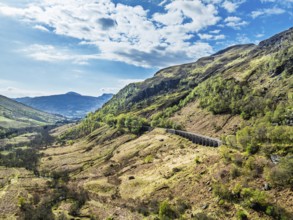 Mountains over Glen Ogle Viaduct from a drone, Road A85, Scotland, UK