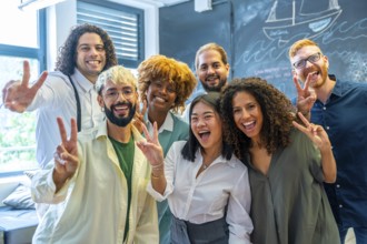 Portrait of a team of young and multiracial cowokers gesturing success
