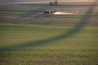 Farmer spraying his meadows in the evening, Bavaria, Germany, Europe