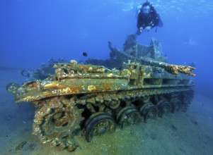 Underwater photo of diver swimming above looking at as an attraction for underwater sportsmen