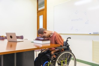 Side view horizontal photo with copy space of a man with cerebral palsy using digital tablet