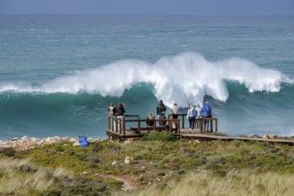 Carrapateira, Algarve, Portugal - Tourists on a viewing platform marvel at the roaring surf and