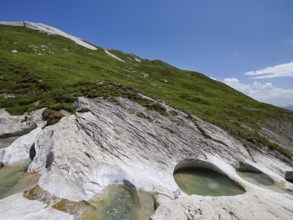 Glacier mill with glacier pots on the Trinser Alp Mora, Trin, Canton Graubünden, Switzerland,