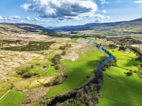 Farms and Mountains over River Dochart and Road A85 from a drone, Perthshire, Scotland, UK