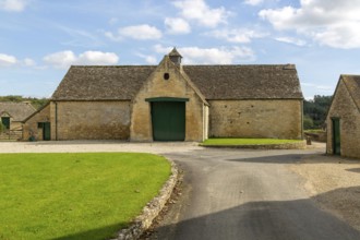 Historic nineteenth century farmyard stone barn building, Yanworth, Gloucestershire, England, UK