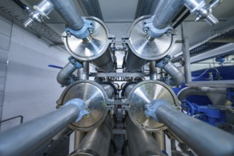 View of an industrial pipe system with many metal elements and blue coatings, ENCW Netze Calw